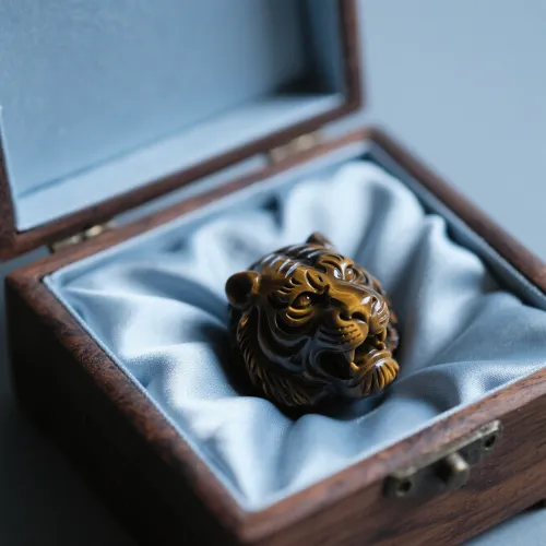 Contemporary tiger's eye pendant layered with minimalist chains demonstrating daily wear versatility